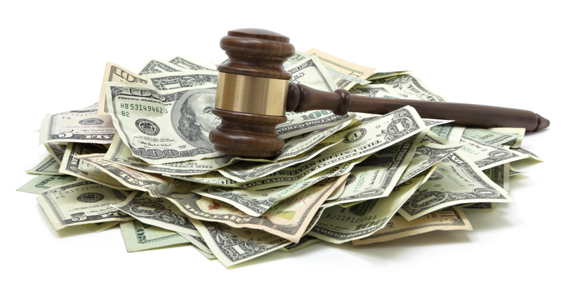 gavel laying on top of money