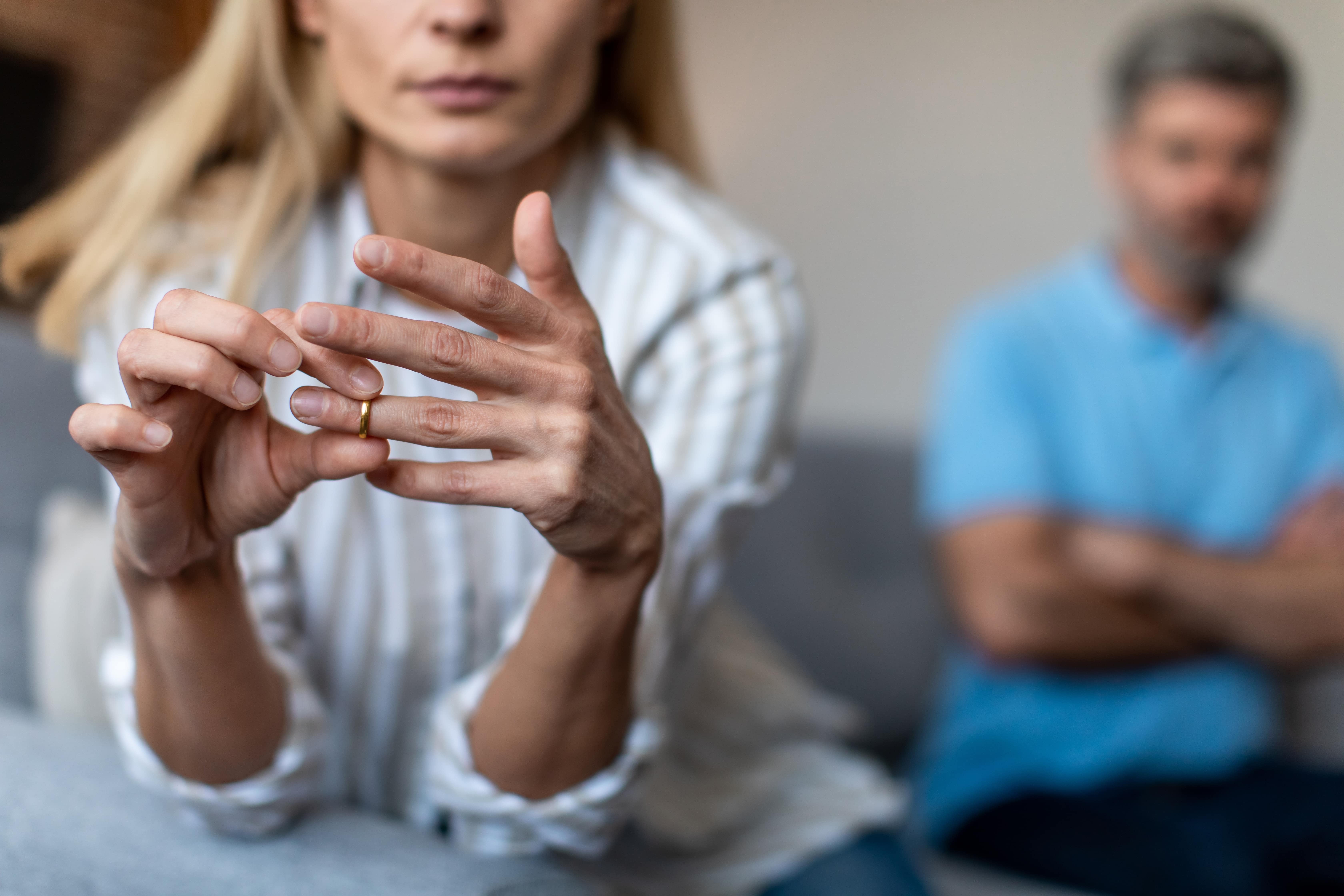 woman taking off wedding ring